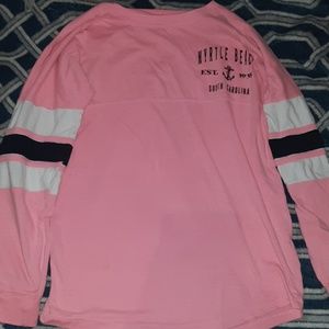 A long-sleeve pink and black and white shirt